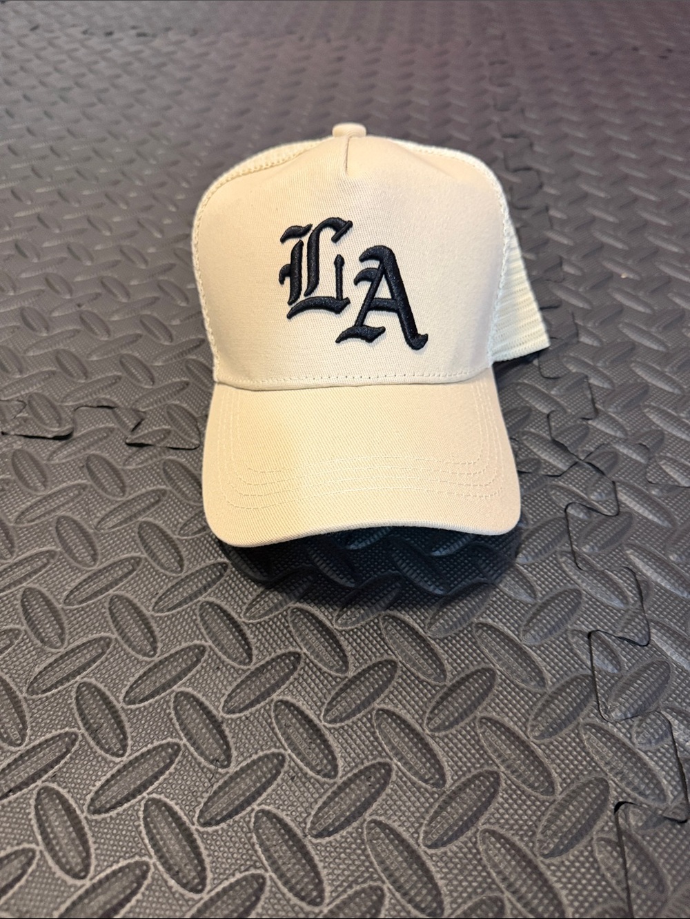 LA Embroidered Trucker Hat in Cream with Black Logo